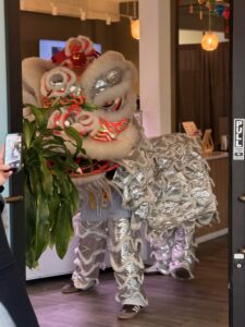 A white lion dancing inside CK Nails and Spa